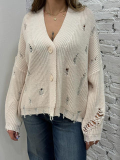 Cardigan con strappi e applicazioni