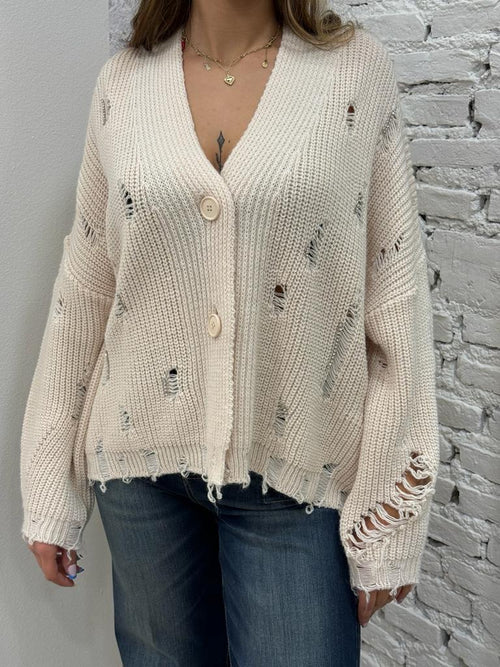 Cardigan con strappi e applicazioni